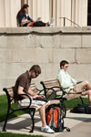Students gather on benches and the steps of Old Capitol as the warm weather allows them to stretch their legs and laptop batteries.