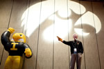 Vince Nelson, president and CEO of the UI Alumni Association, shares the stage with a blow-up Herky while making announcements at the pregame tailgate.