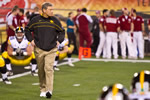 Iowa head football coach Kirk Ferentz walks the field as the team stretches and warms up before the Insight Bowl.