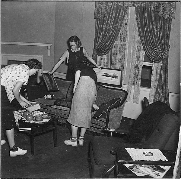 Drama students arranging furniture and props on a set, 1930s 
