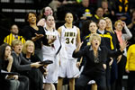 The Iowa bench, including women’s basketball coach Lisa Bluder (front, right), react to a play during the Hawkeyes’ 69-57 victory over Wisconsin Jan. 19.