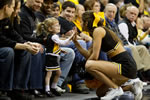Iowa cheerleader Julie Blumberg helps cultivate Hawkeye spirit in a young fan during Iowa’s 78-66 men’s basketball victory over Indiana on Feb. 19.