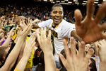 Sophomore forward Melsahn Basabe celebrates with fans Feb. 23 after the men’s basketball team scored its second triumph of the year over Wisconsin. The 67-66 victory marked the Hawkeyes’ fourth win over a Top 25 team this season.