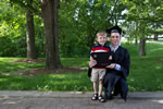 A graduate strikes a pose with his son after the ceremony.
