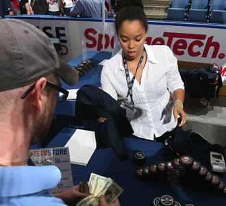 Brittany Kachingwe helps sell merchandise for the New York Islanders hockey team.