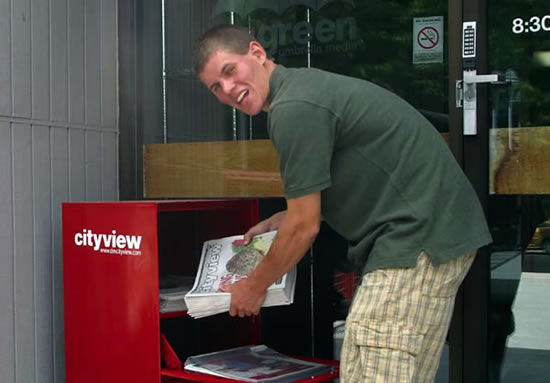 Nick Fetty loads copies of Cityview newspaper into one of the publication’s boxes in Des Moines.