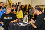 A Hawkeye fan stops to get an autograph from 'American Pickers' reality TV star Frank Fritz, who gave a presentation about collecting and answered questions.
