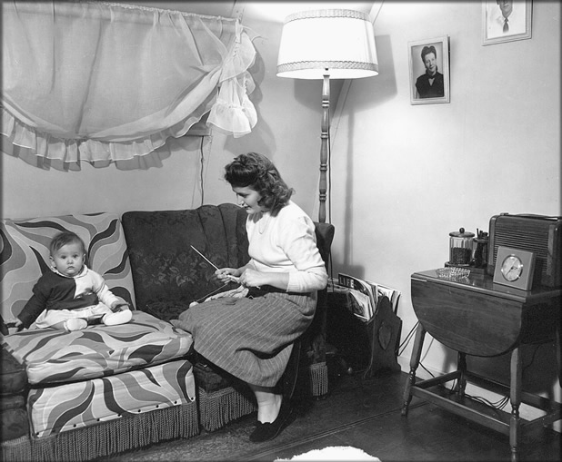 Mother with child in a temporary housing unit (location unknown), 1948