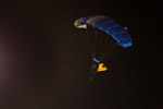 A parachuter flying a Hawkeye flag does a precision landing in the middle of Sun Devil Stadium before kickoff.